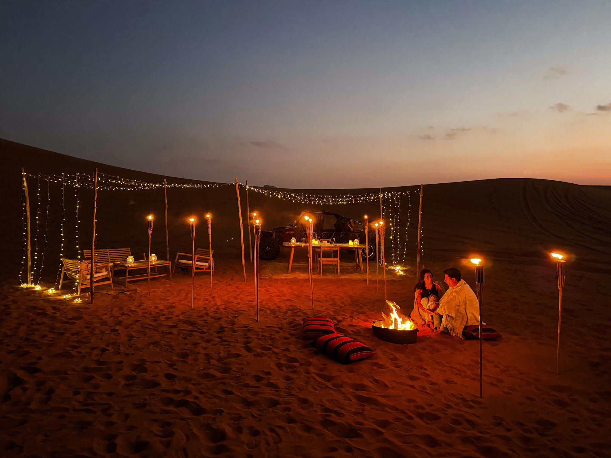 Romantic private dinner at night in the dunes at Zerzura desert camp
