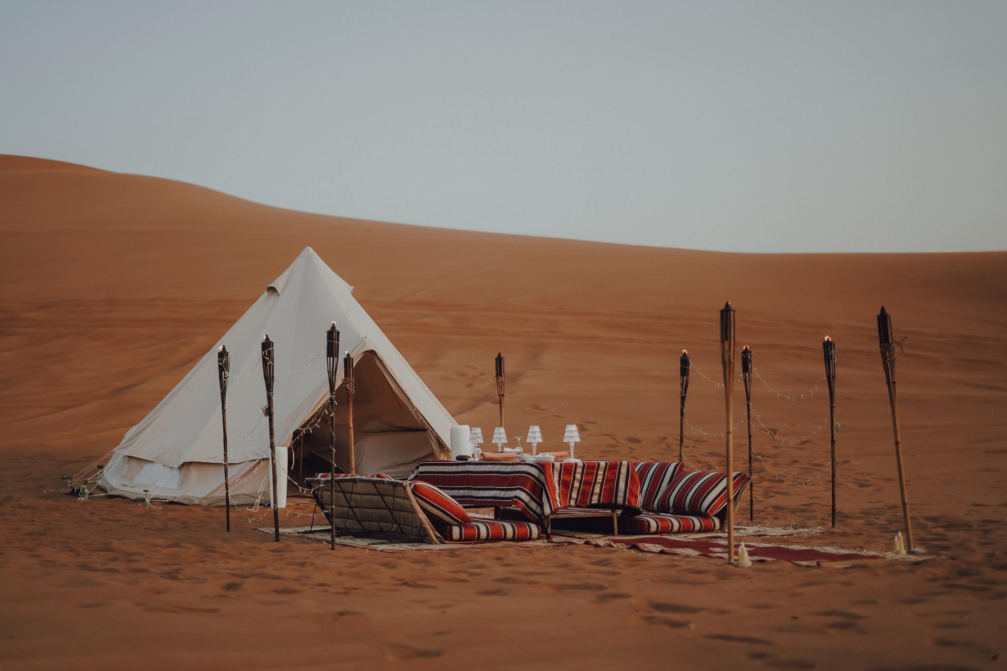 Private desert glamping camp with Bedouin lounge seating in Mleiha near Dubai