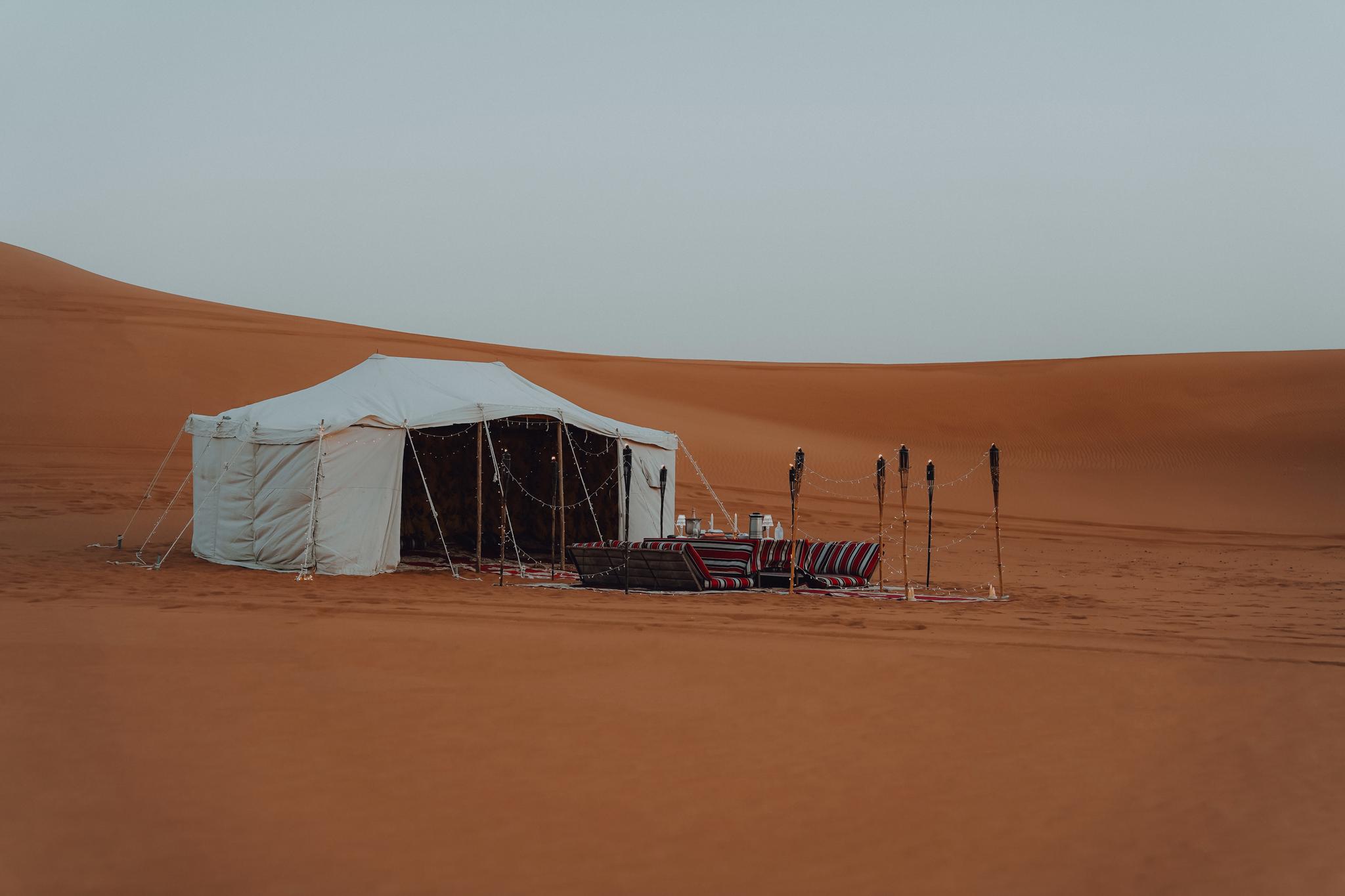 Luxury glamping tent and private lounge seating at Zerzura Experiences Mleiha desert